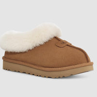 Brown slipper with white fur lining on a light gray background