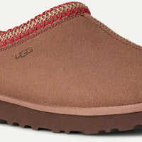 Brown UGG slipper with red interior on a white background