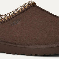 Brown slipper with textured trim on a light gray background