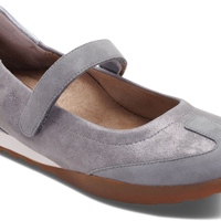 A light gray suede Mary Jane flat shoe with a brown gum sole, shown from a three-quarters angle on a white background.