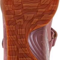 Close-up of the textured orange-brown sole of a pink shoe, showing the 'detrex' brand logo on the heel.