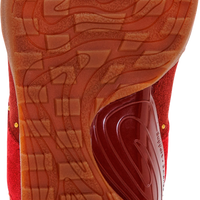 Close-up of the textured orange-brown outsole of a red athletic shoe, showing the Gel-FX cushioning system and a white circular Gel logo.