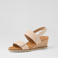 Ziera Kift wedge sandal in natural-toned raffia with adjustable straps, cushioned footbed, and mid-height wedge sole on a white background