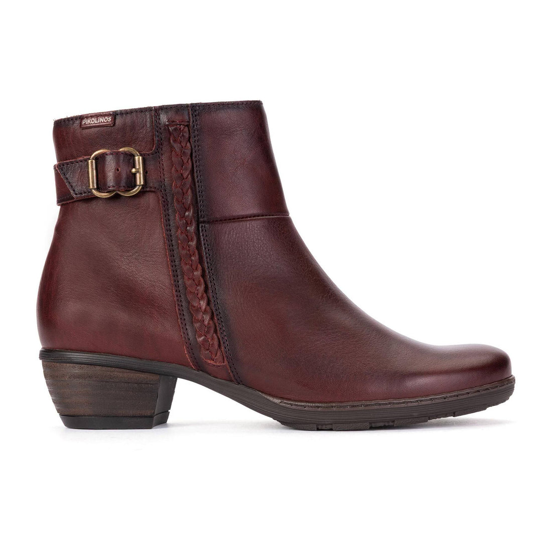 A dark burgundy leather ankle boot with a low block heel, a decorative side strap with a gold buckle, and a braided detail on the side, shown against a plain white background.