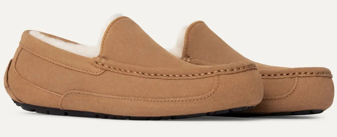 Tan slip-on shoes with white lining on a light gray background