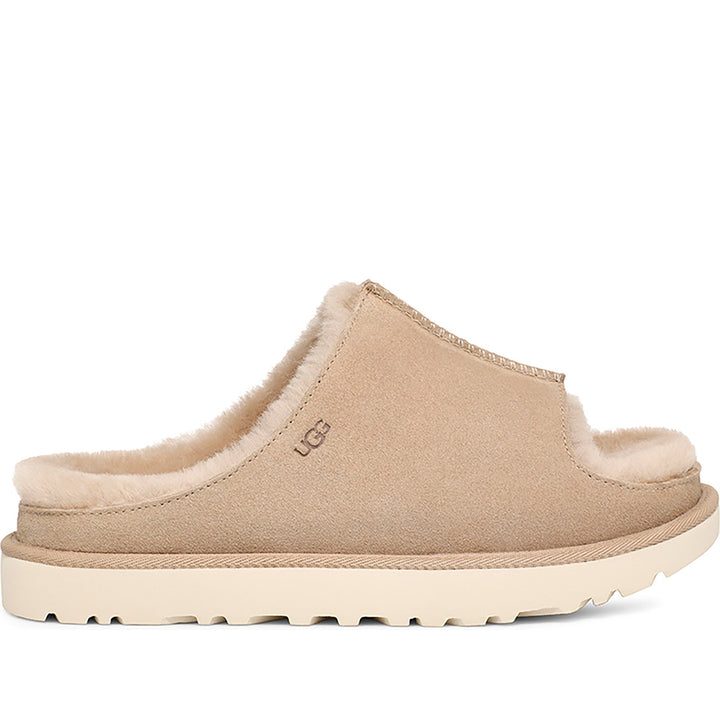 Quarter turn Women's UGG Footwear style name Greenport Slide in color Sand. Sku: 1167610-SAN
