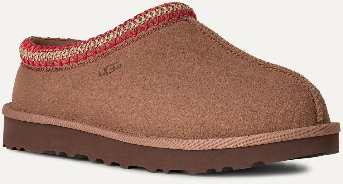 Brown UGG slipper with red interior on a white background