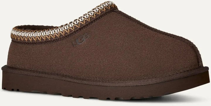 Brown slipper with textured trim on a light gray background