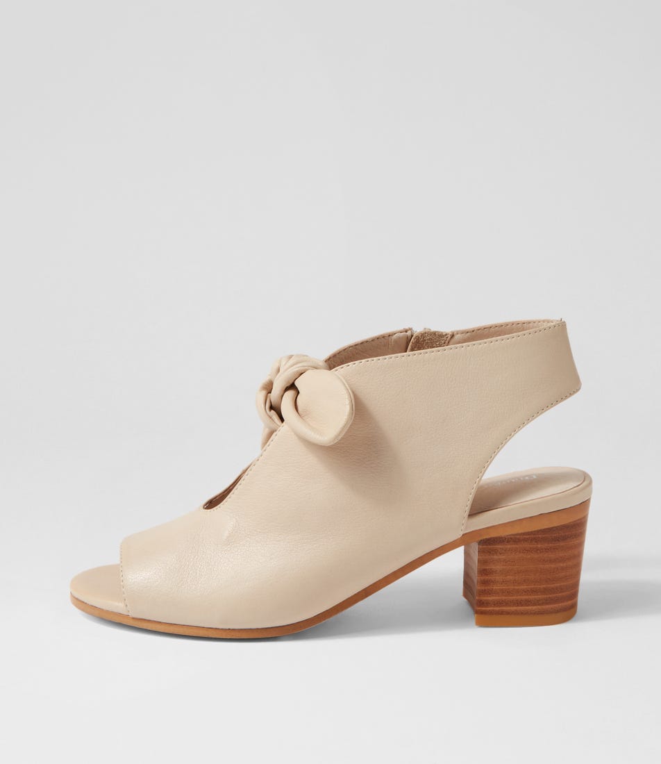 Beige sandal with wooden heel on a light gray background