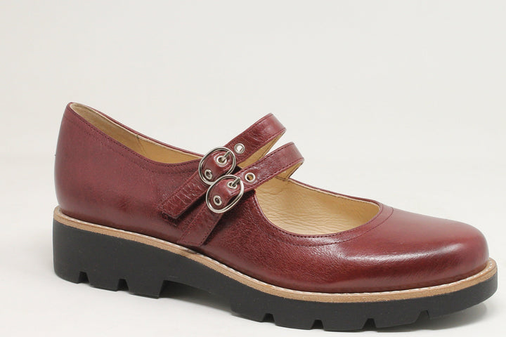 Brown leather shoe with a strap on a white background