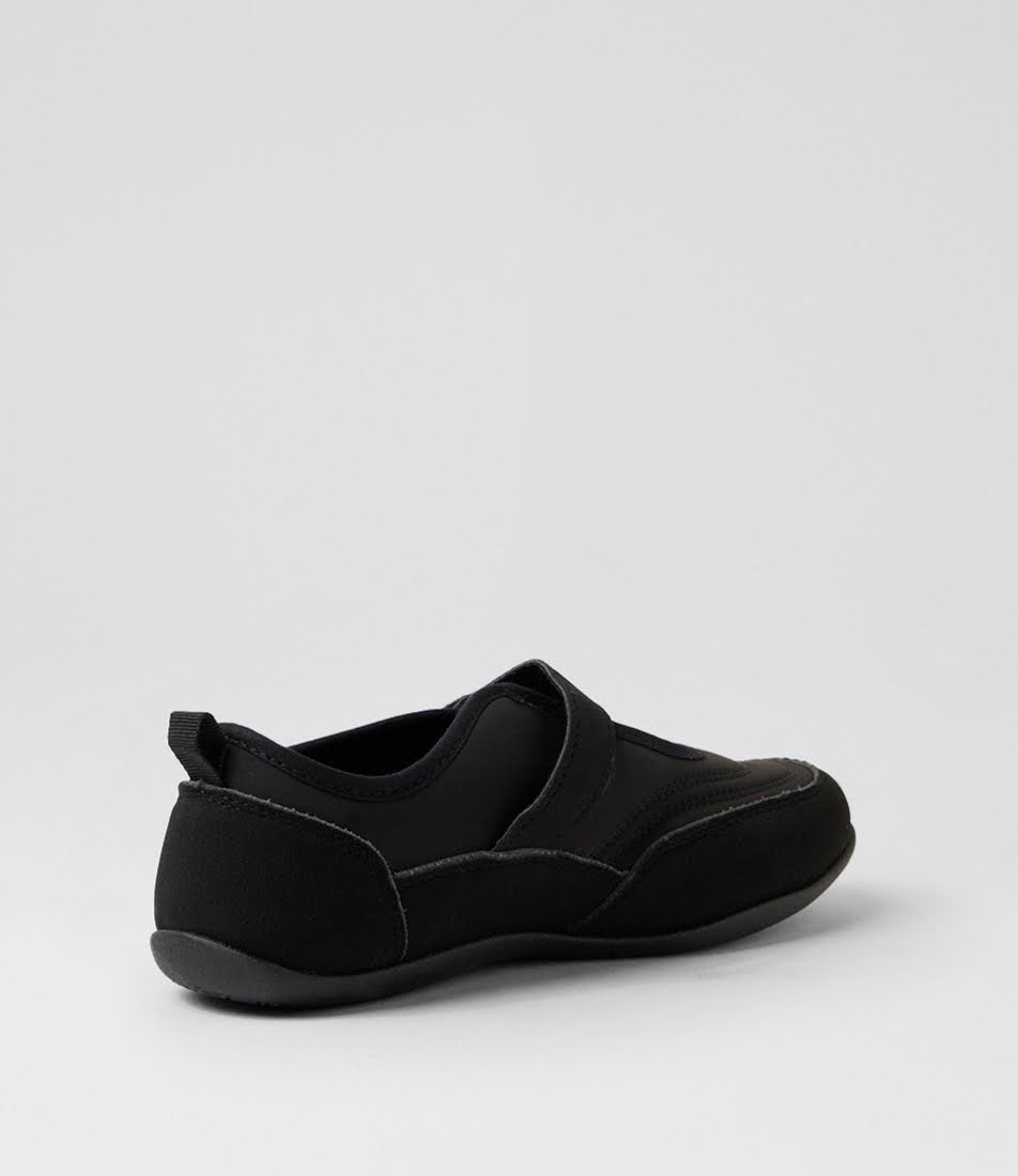 A black slip-on shoe with a wide strap and a pull tab at the heel, shown from a side-rear angle on a light gray background.