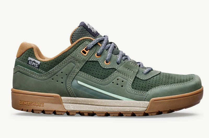 Green hiking shoe with brown sole on a white background