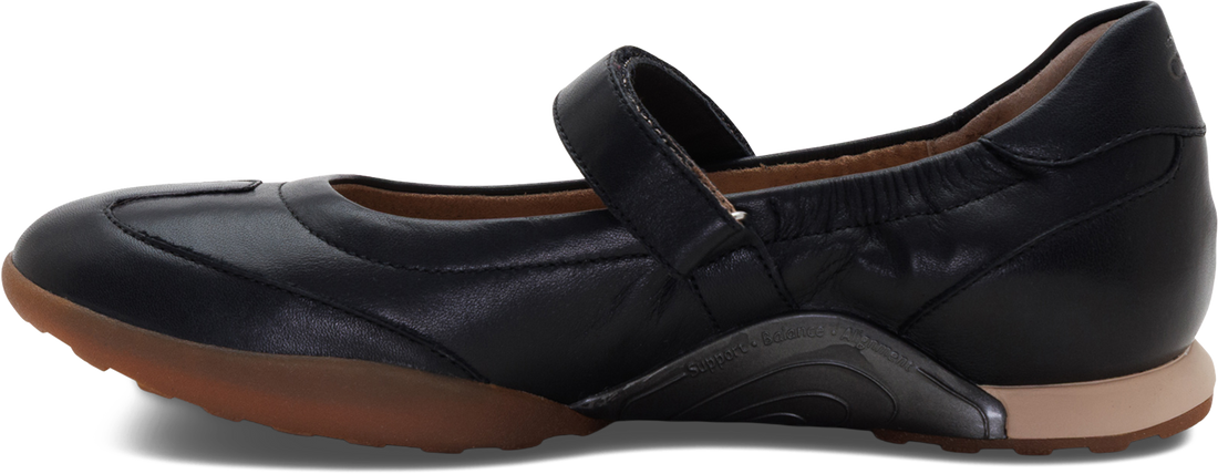 A black leather Mary Jane flat shoe with a hook-and-loop strap, shown in a side profile view against a white background.