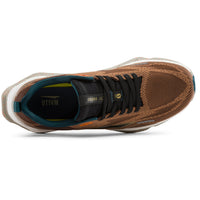 A single athletic sneaker shown from a top-down view on a clean white background. The shoe features a brown knit upper, black laces, a teal inner lining, and a white midsole.