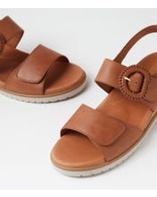 Ziera Vatch wedge sandal in tan leather with adjustable straps, cushioned footbed, and mid-height wedge sole on a white background